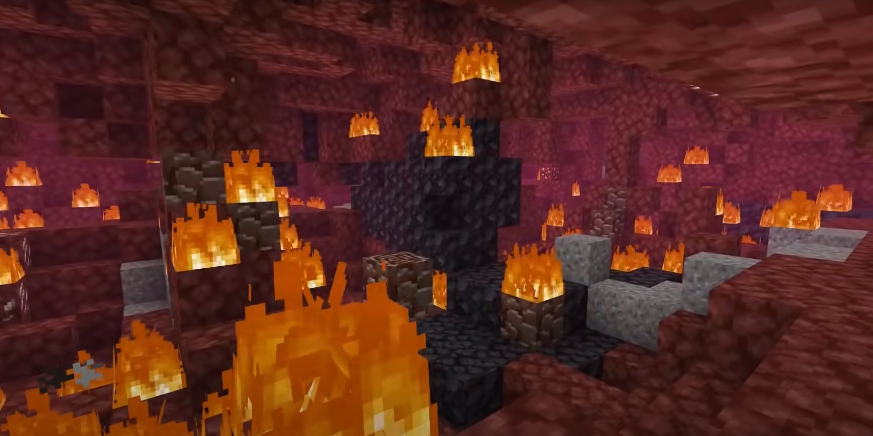 An image of the Nether in Minecraft with lots of areas on fire
