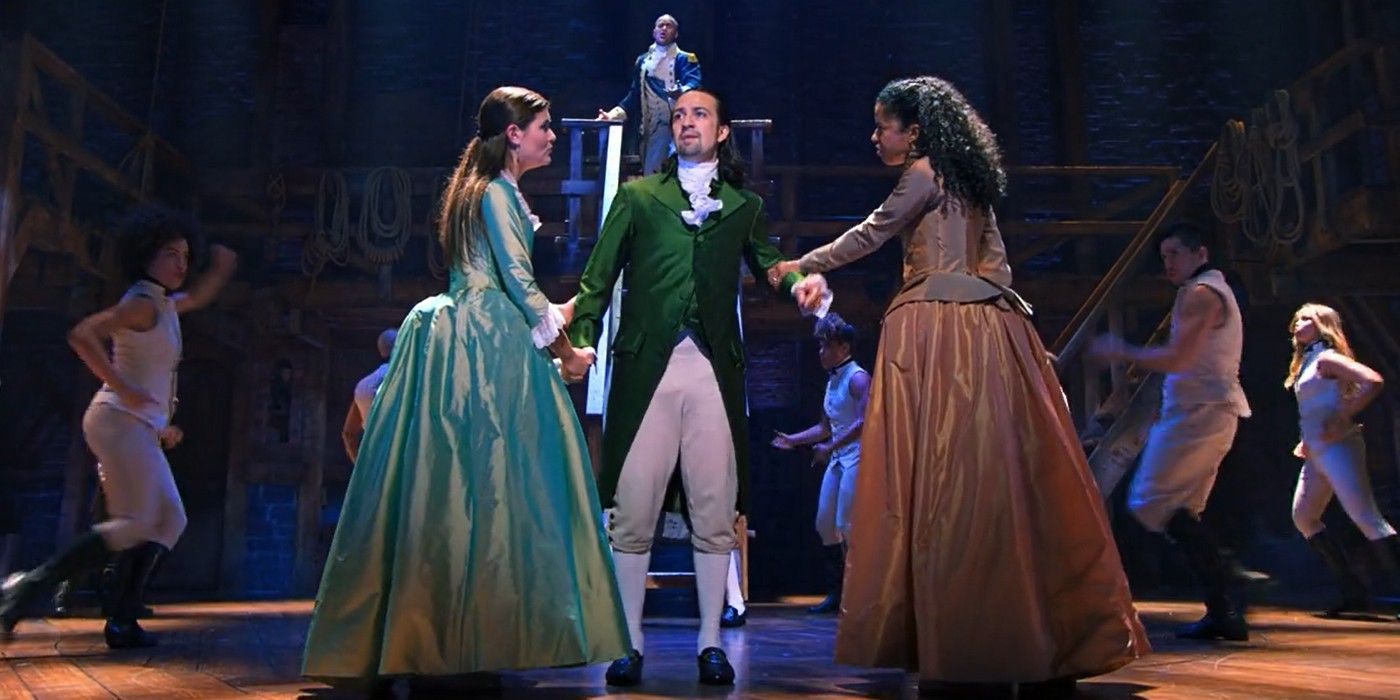 Alexander Hamilton (Lin-Manuel Miranda) being pulled by the Schuyler sisters (played by Phillipa Soo and Renee Goldsberry)