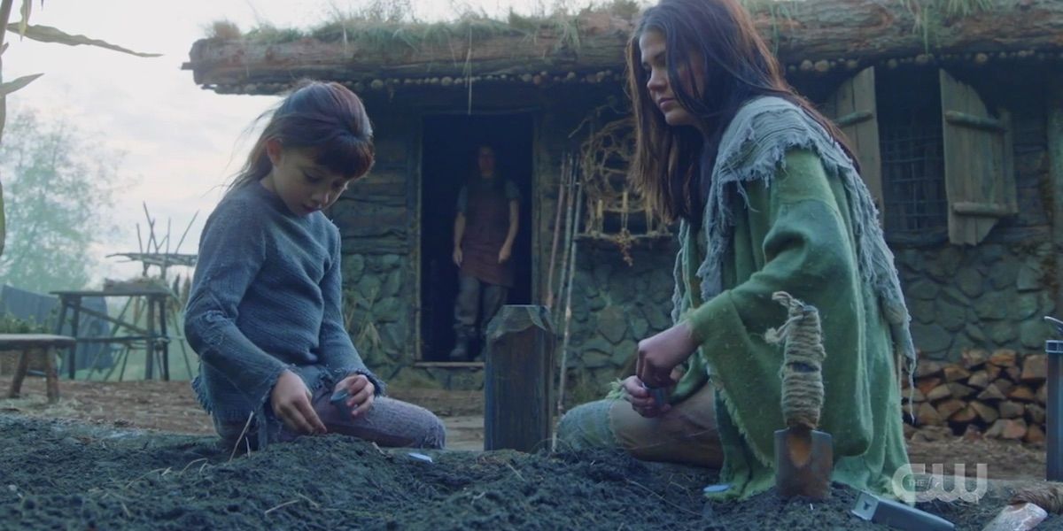 Octavia plants seeds in the garden with Hope in The 100
