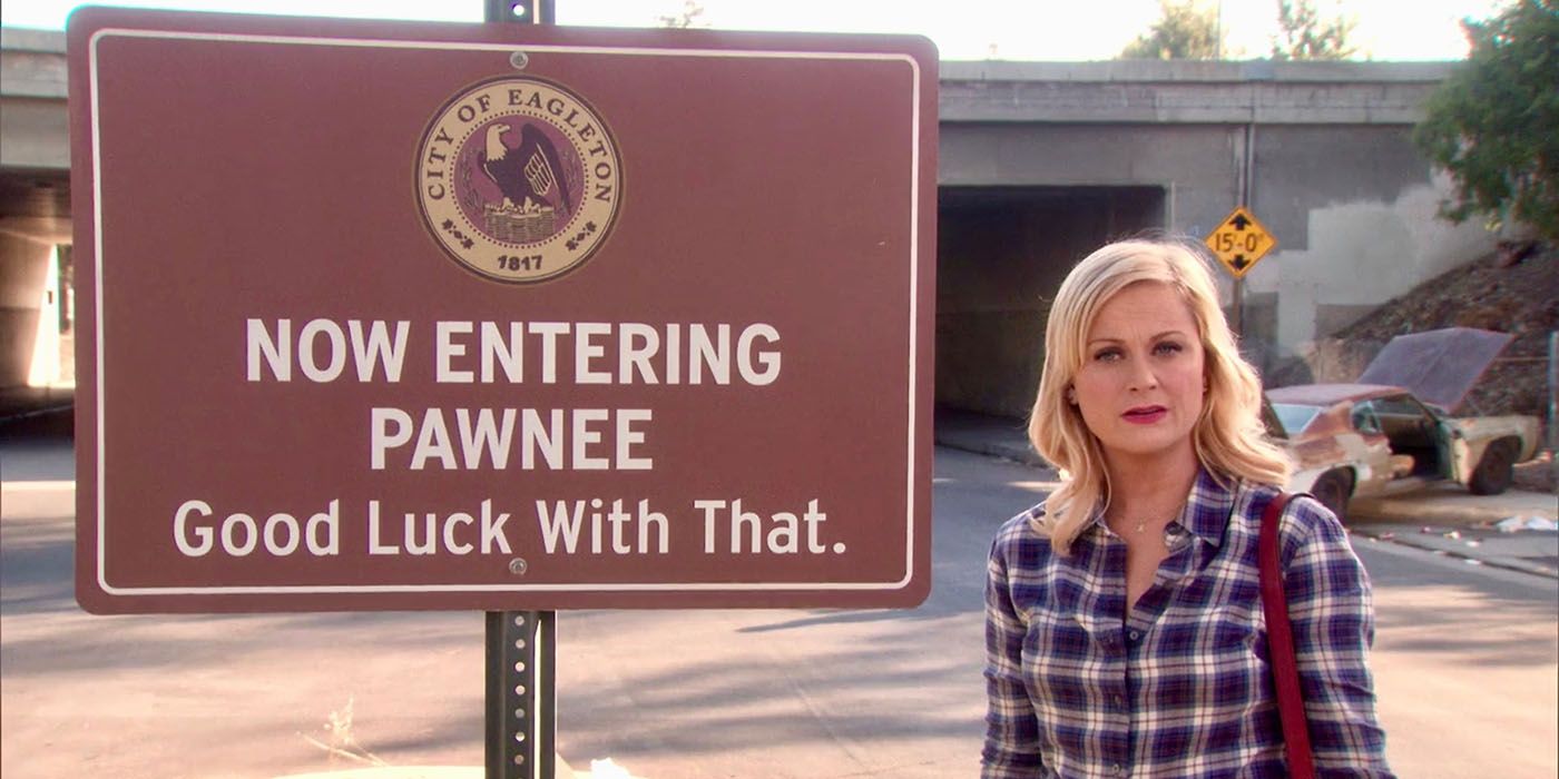 Leslie Knope in front of an Eagleton posted sign