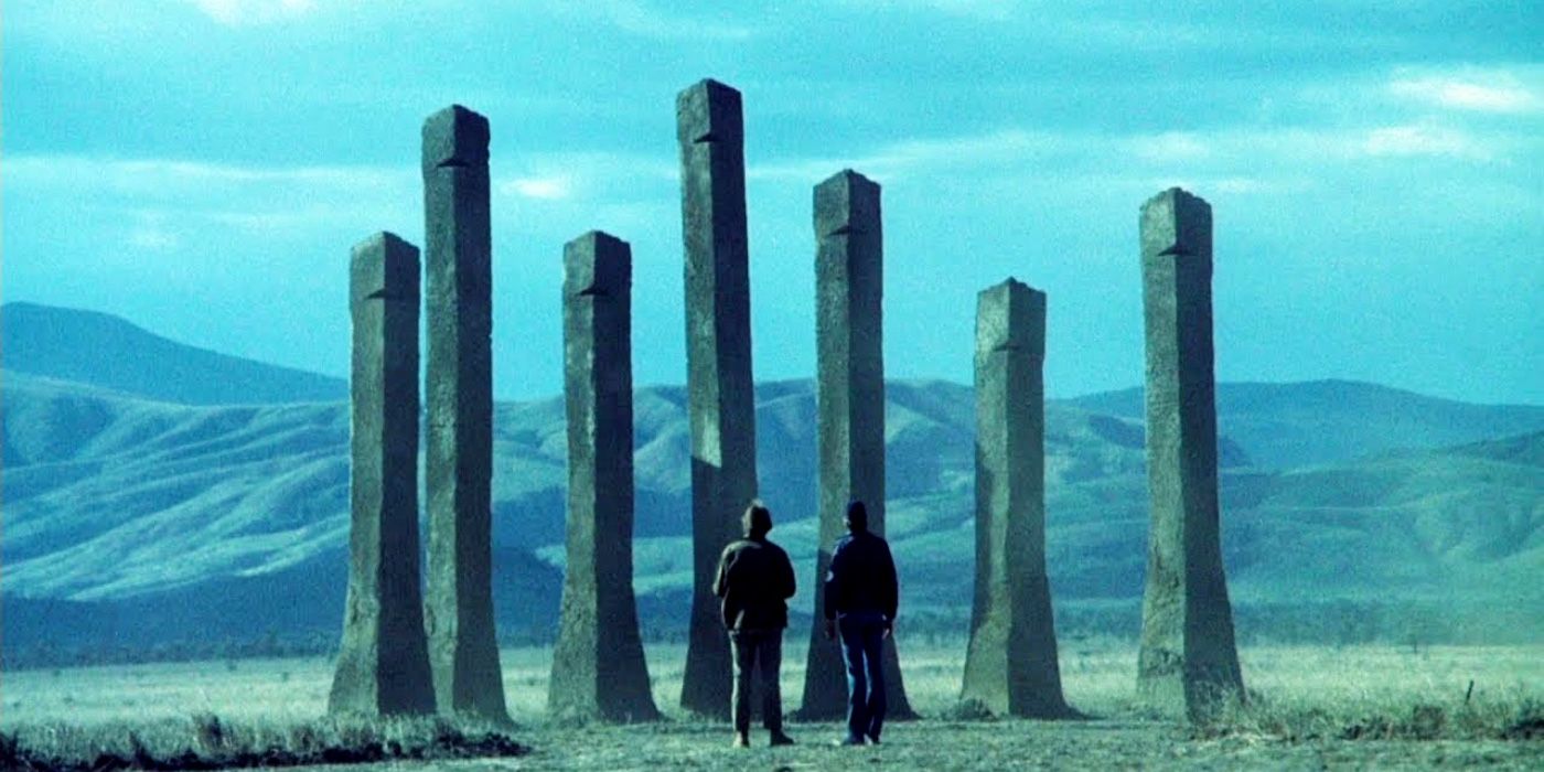 Two people look at statues in Phase IV