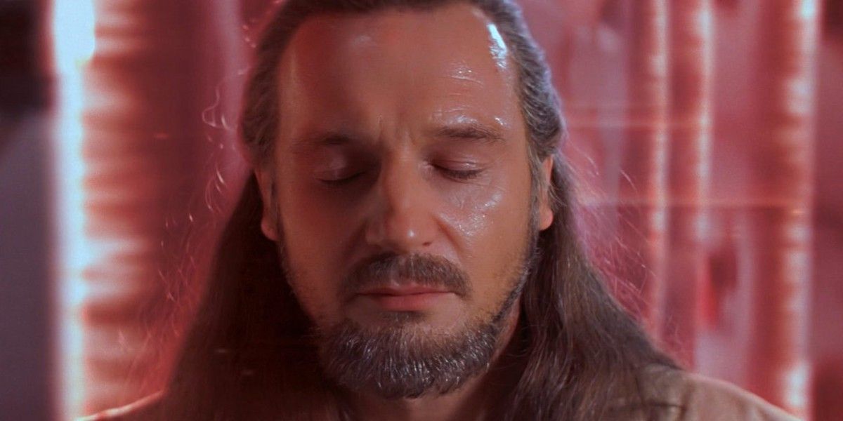 Qui-Gon waiting calmly behind a laser barrier in The Phantom Menace