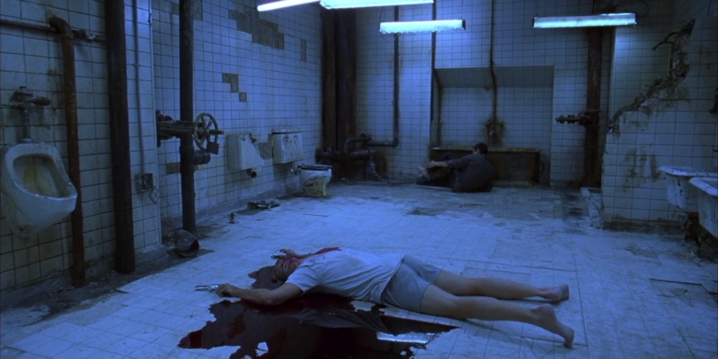Kramer lying in the centre of the Bathroom in Saw