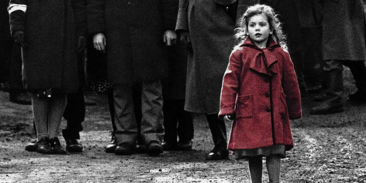 The girl in the red coat walking in the street with people behind her in Schindler's List