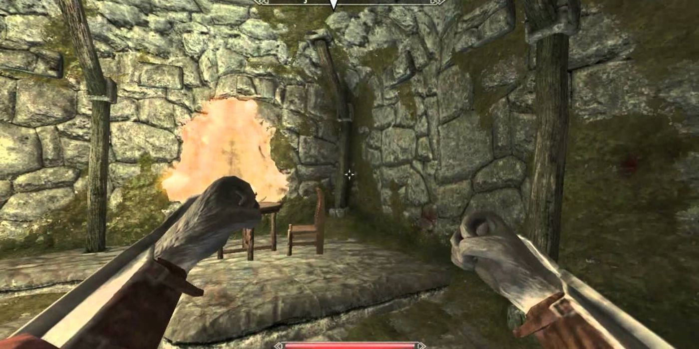 Khajiit arms with fists raised first person view towards stone wall