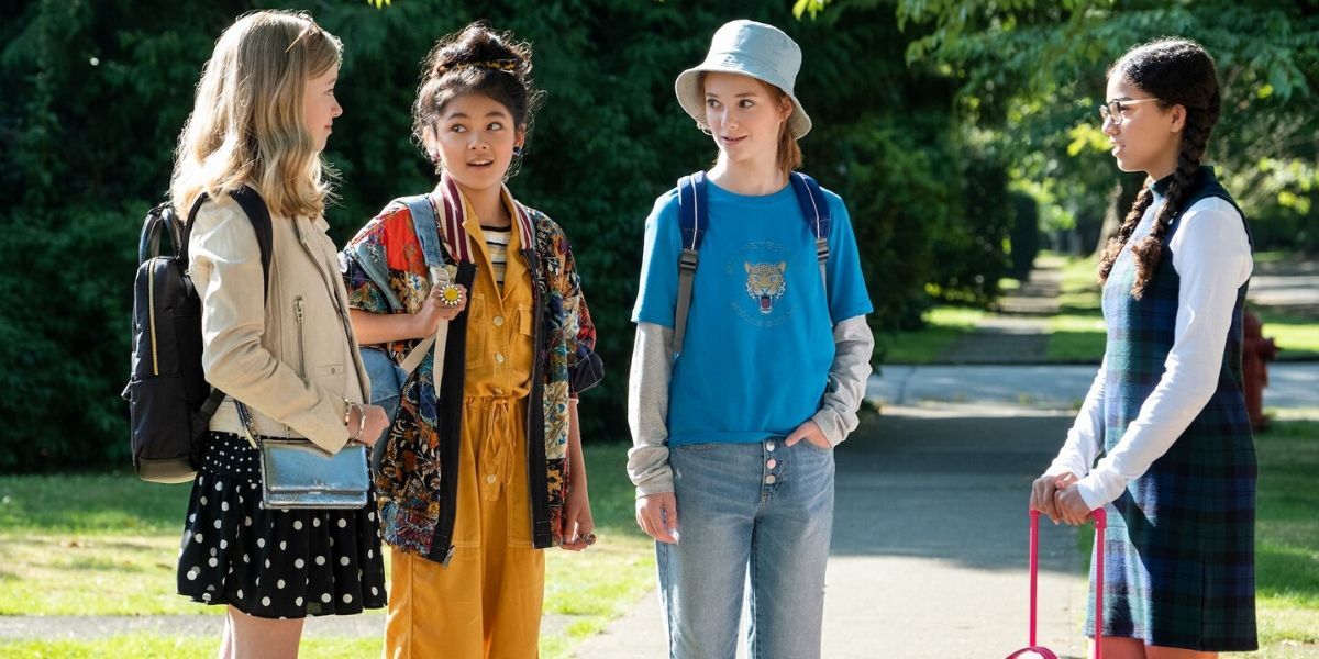 The girls in The Baby-sitters Club talking on the sidewalk.