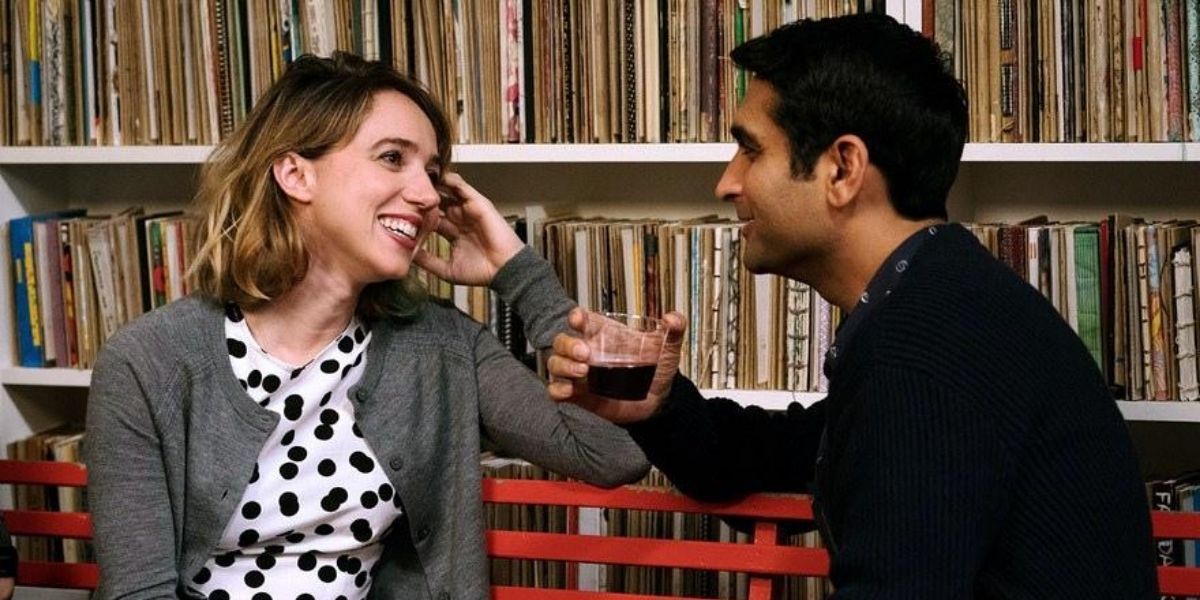 Zoe Kazan laughs and talks with Kumail Najiani on a bench in The Big Sick