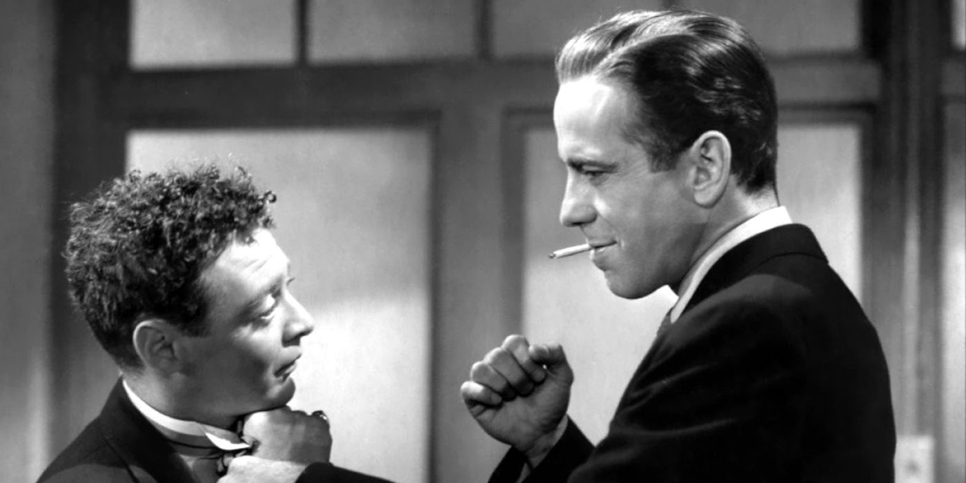 Sam Spade clenches his fist against Peter Lorre in The Maltese Falcon.