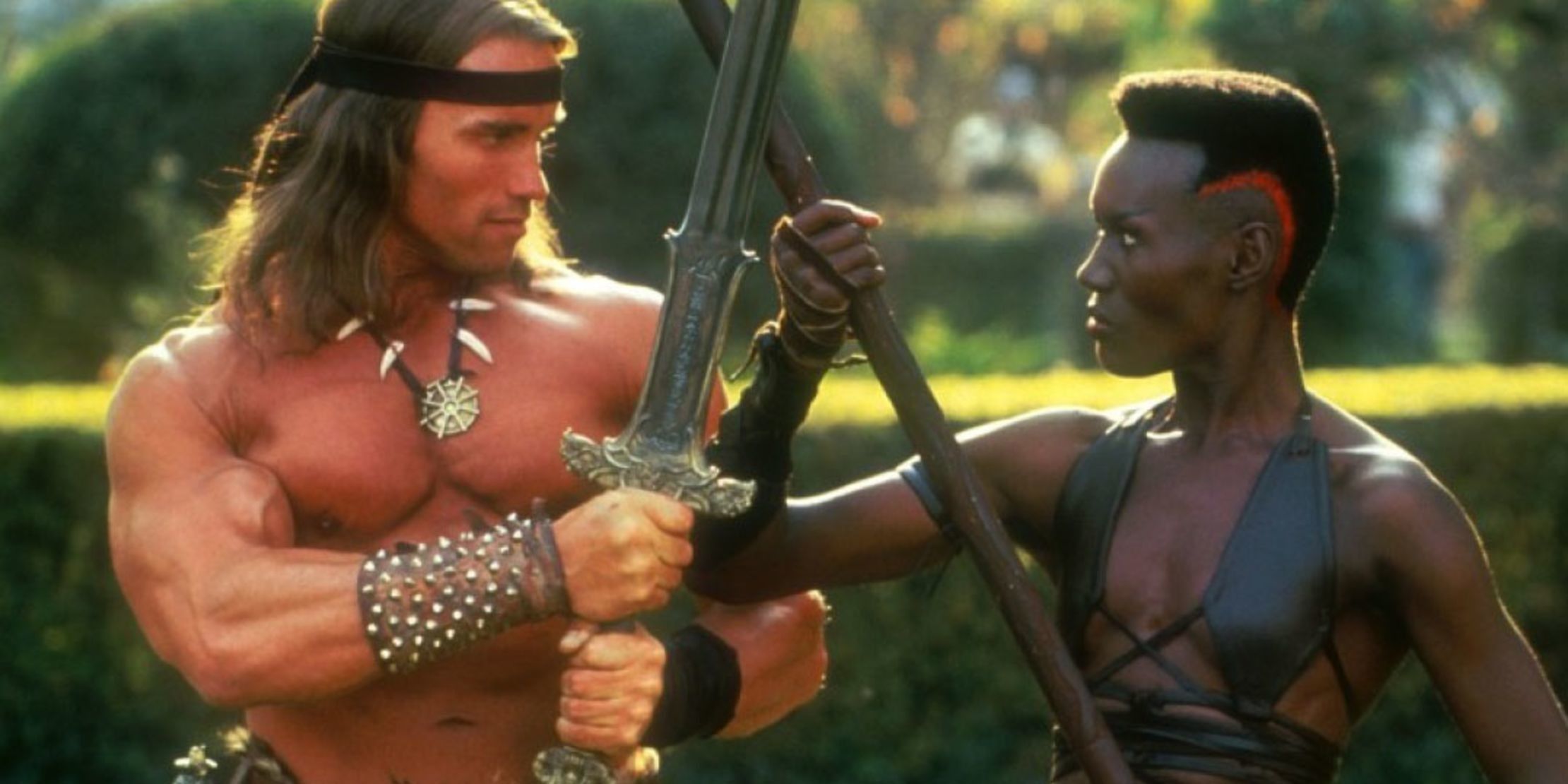 Conan and Zula crossing weapons in publicity still for Conan the Destroyer