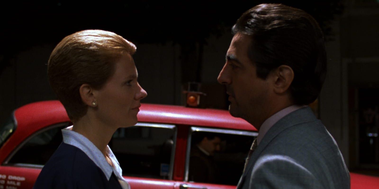 Joe Mantegna and Lindsay Crouse looking at each other in House of Games