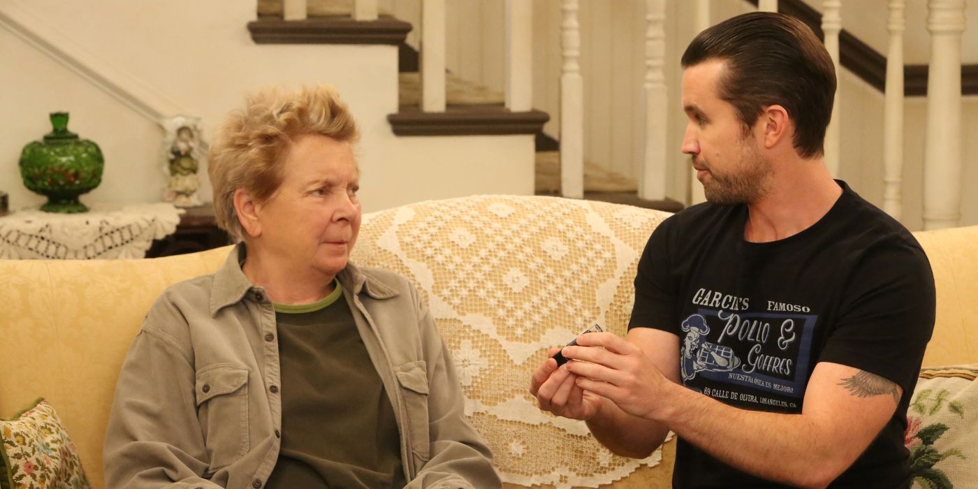 Mac sitting on the couch with his mom in It's Always Sunny in Philadelphia.