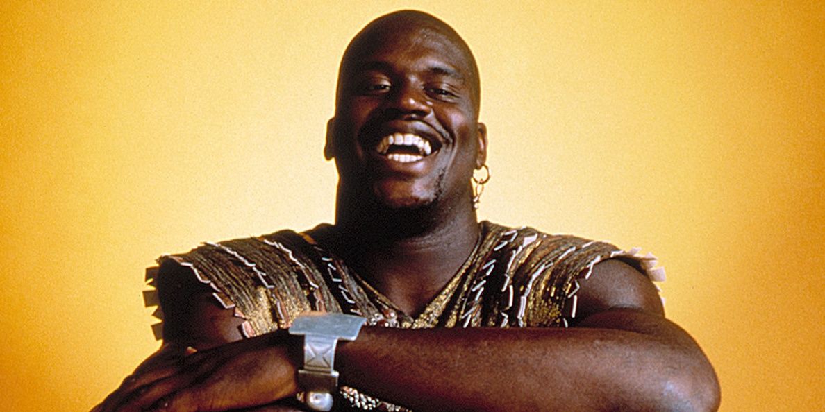 Kazaam smiling with his arms crossed