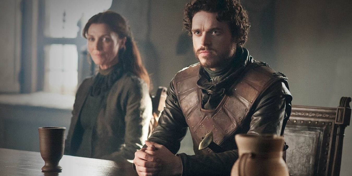 Robb and Catelyn Stark sit together at a table in Game of Thrones