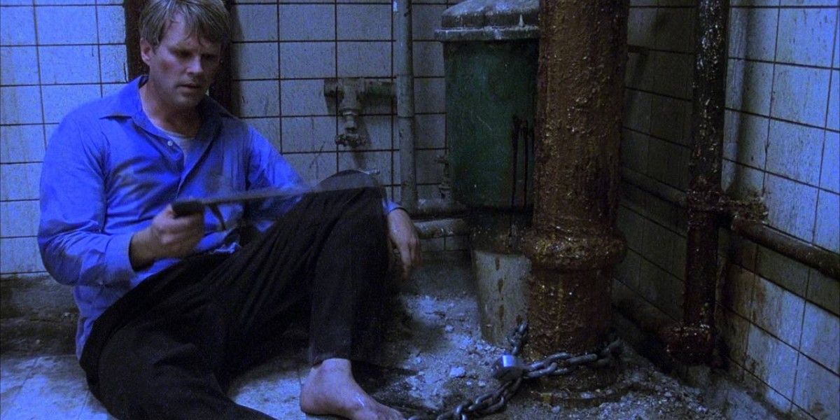 Cary Elwes in 2004's Saw sitting on the floor.