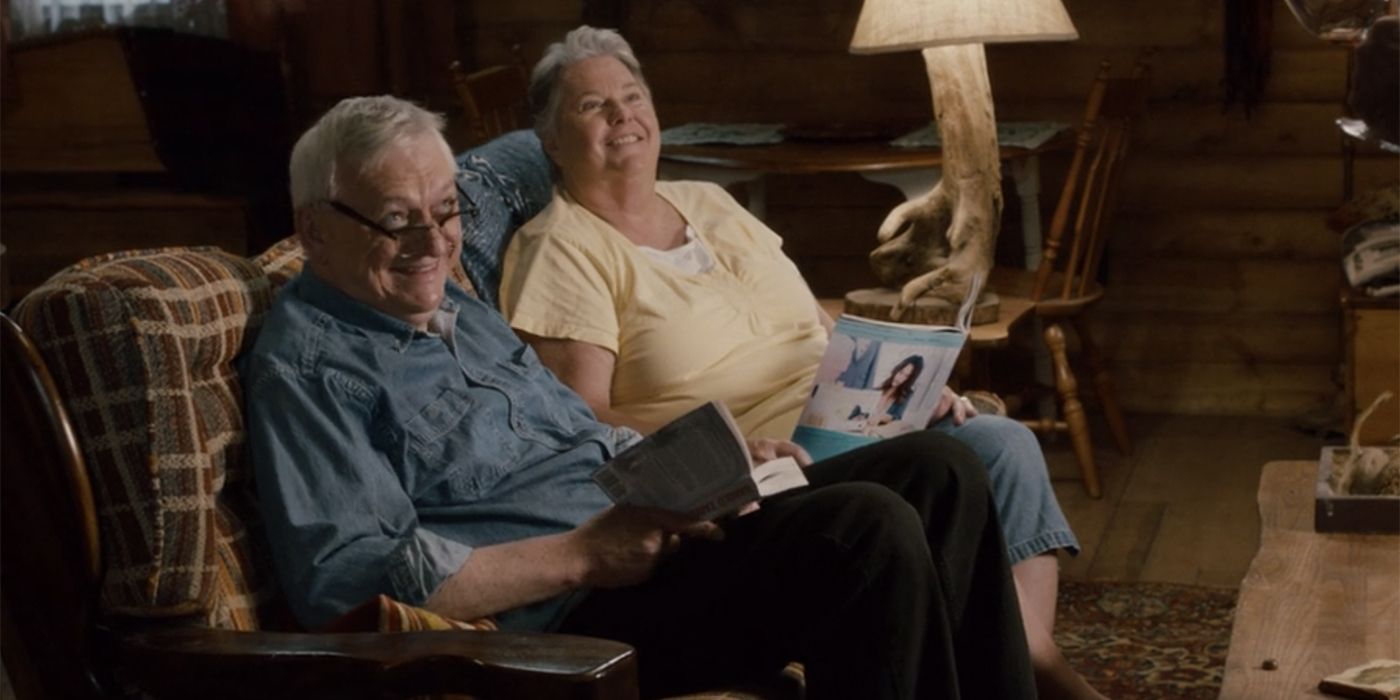 Gwen and Bob sitting together in the cabin on Schitt's Creek