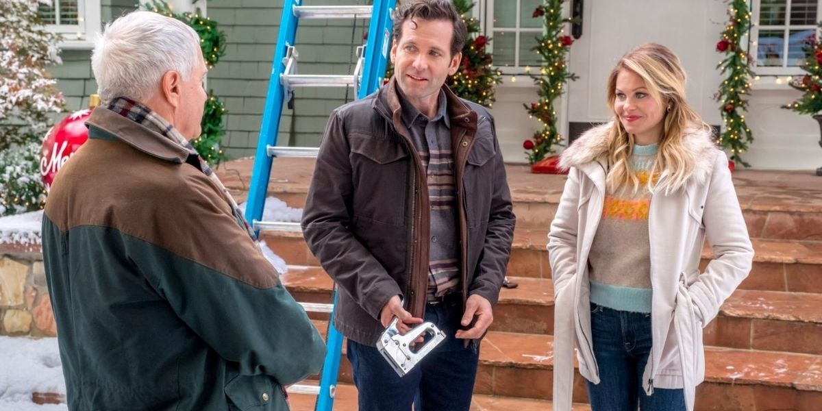Two characters standing outside talking with a man in a Christmas Hallmark movie