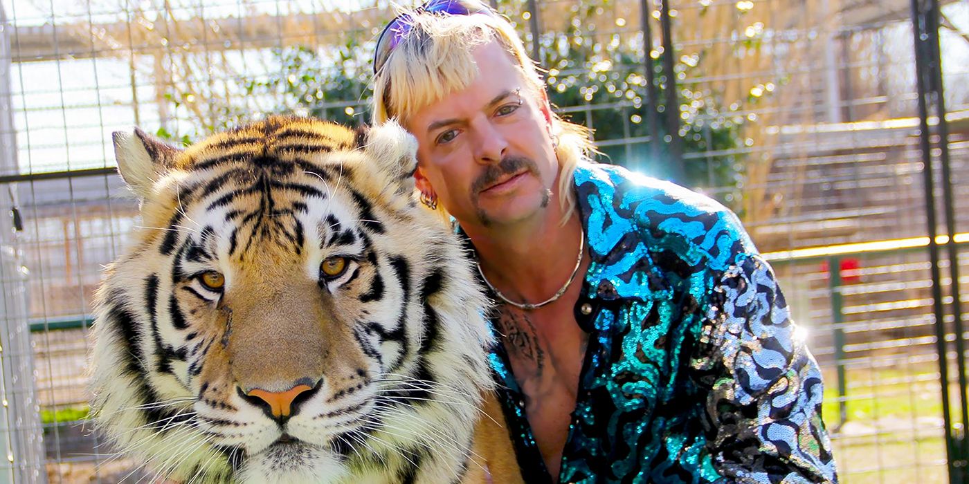 Tiger King posing next to his tiger