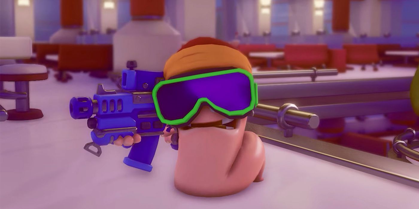 A wom wearing snowboarding goggles and holding a blue machine gun