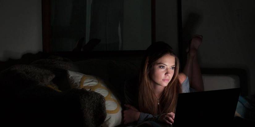 Ashley Benson on her laptop in a dark room in Ratter