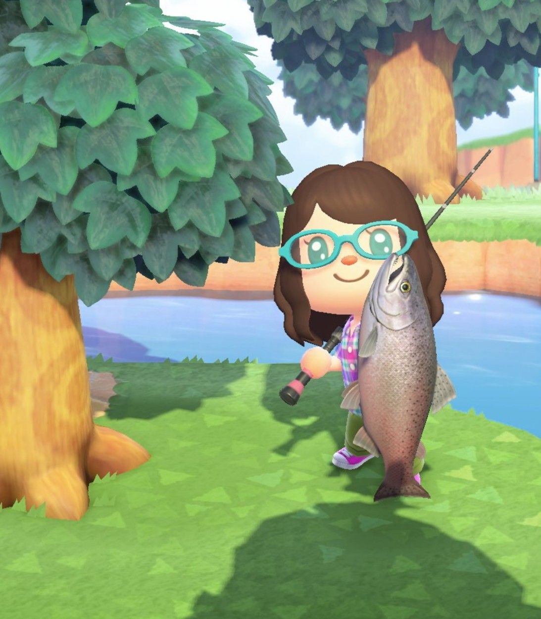 A player catches a King Salmon from the river in Animal Crossing: New Horizons