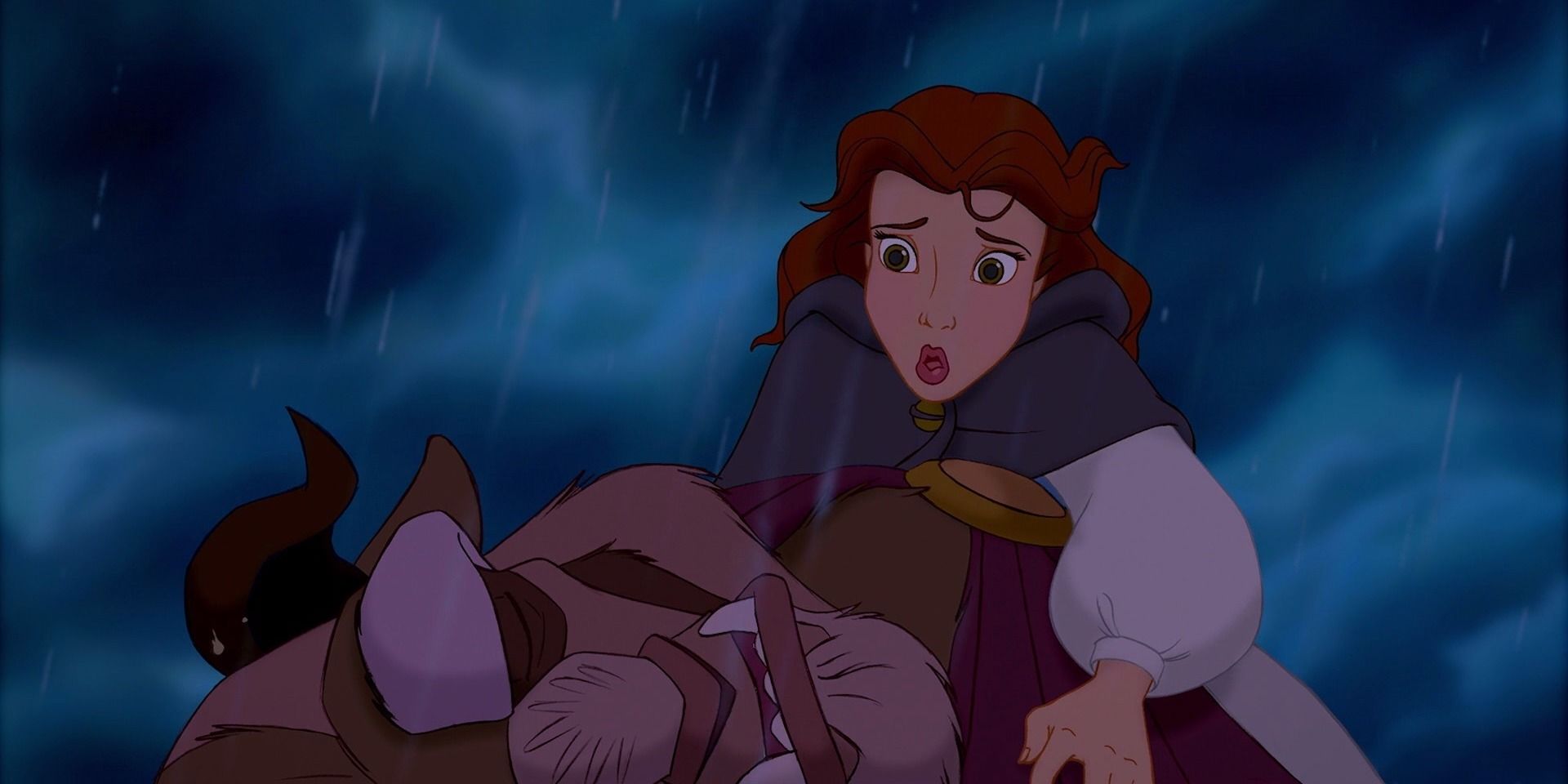 Belle looks concerned over a dying beast in Beauty and the Beast