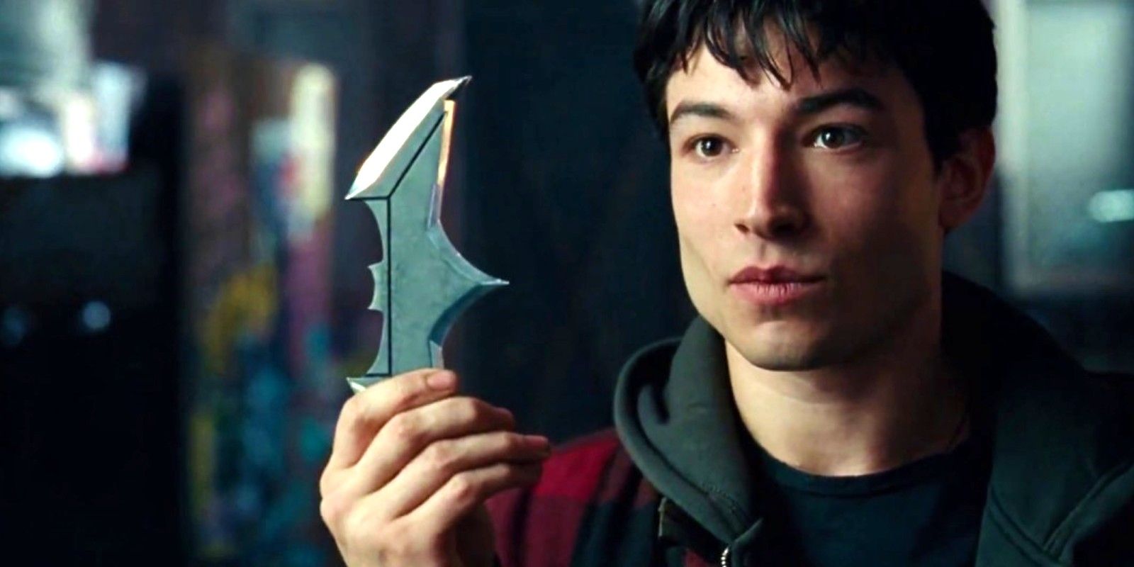Flash holding a Batarang in Justice League