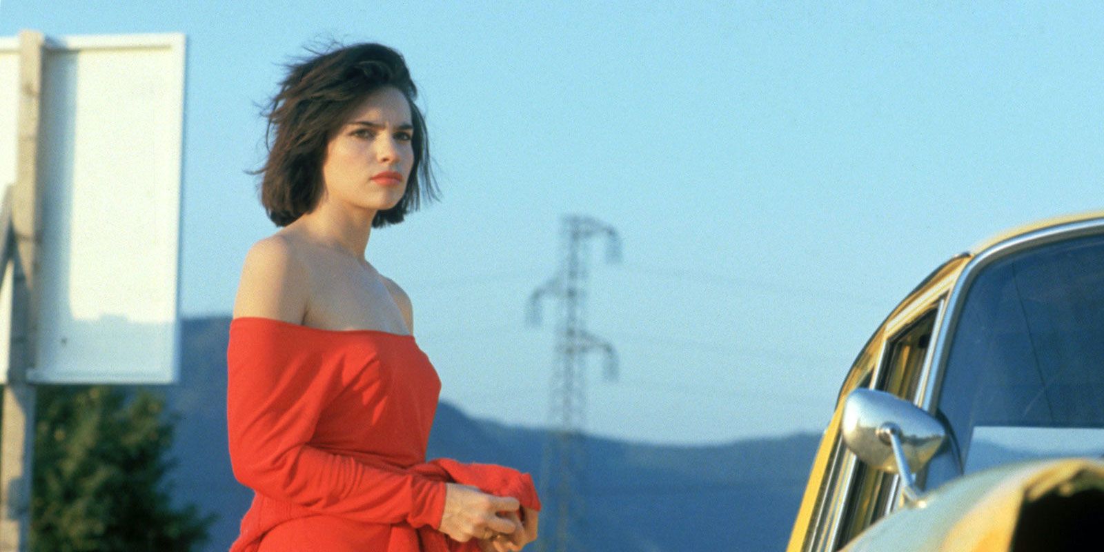 Betty standing by a car in Betty Blue.