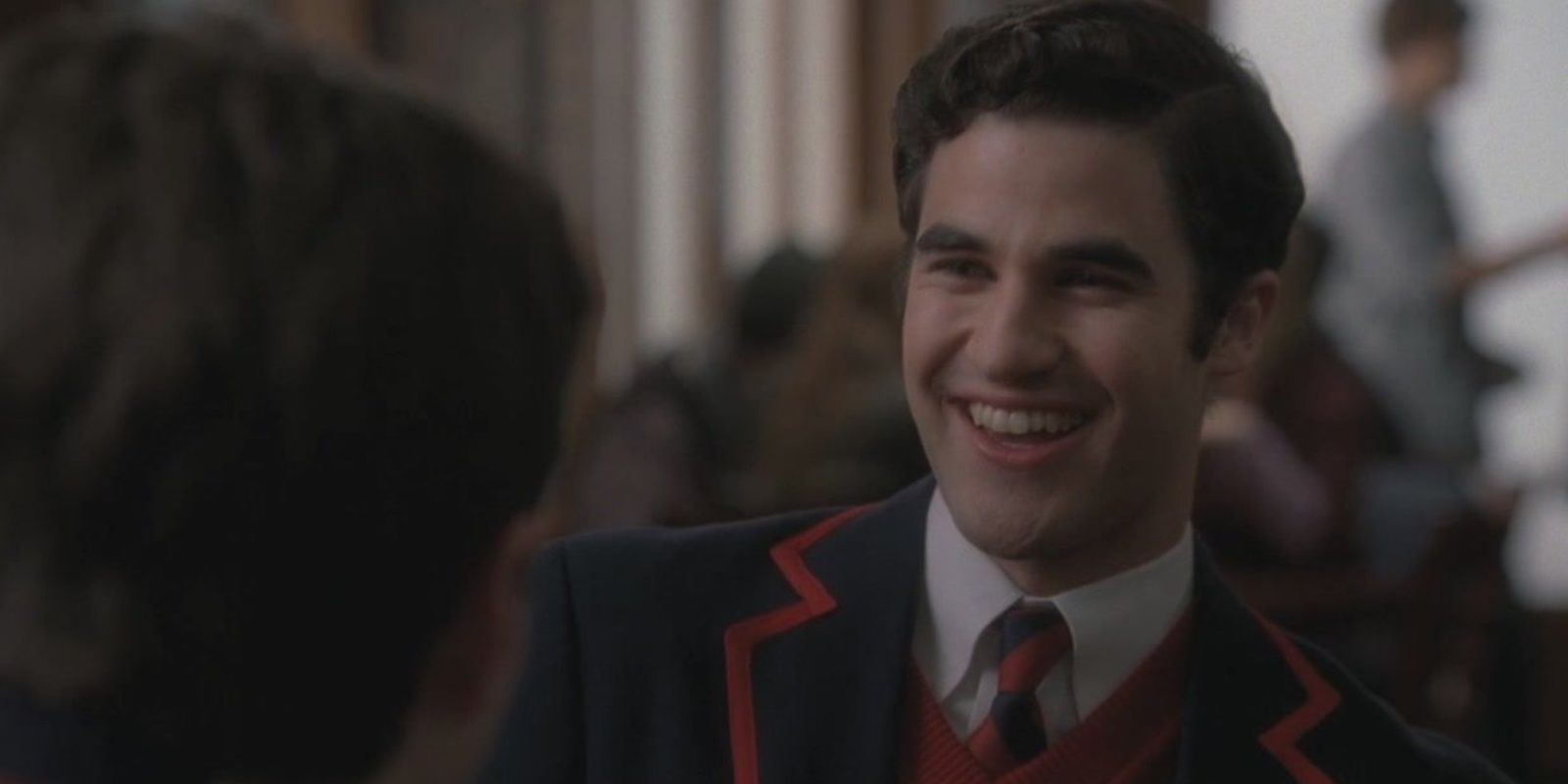 Blaine Anderson laughing in his school uniform