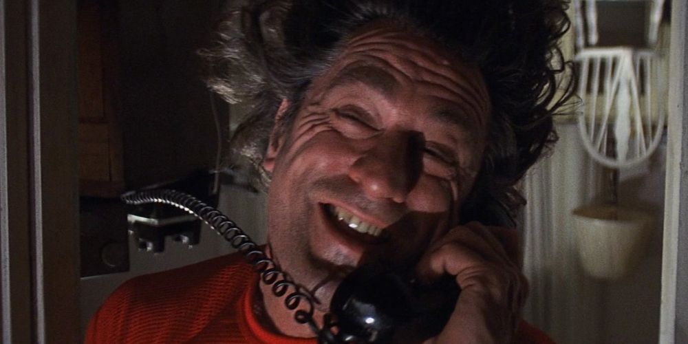Max speaks on the phone while hanging upside down from Cape Fear