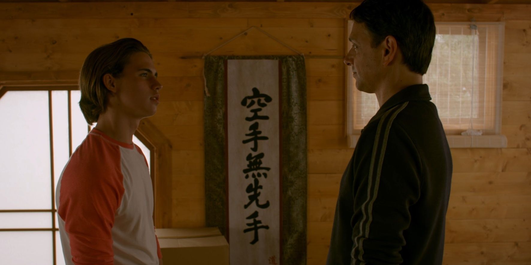Robby and Daniel talk in the dojo in Cobra Kai