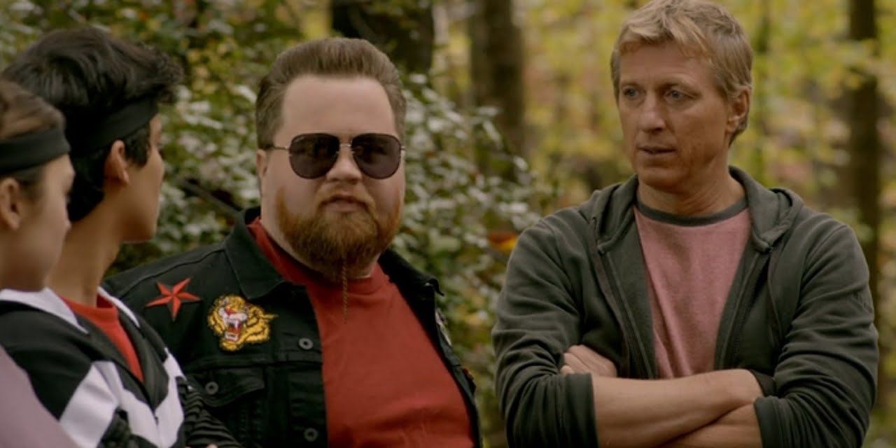 Stingray and Johnny in the woods with Cobra Kai students