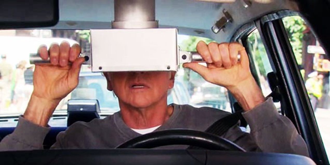 Larry looks through the car periscope in Curb Your Enthusiasm