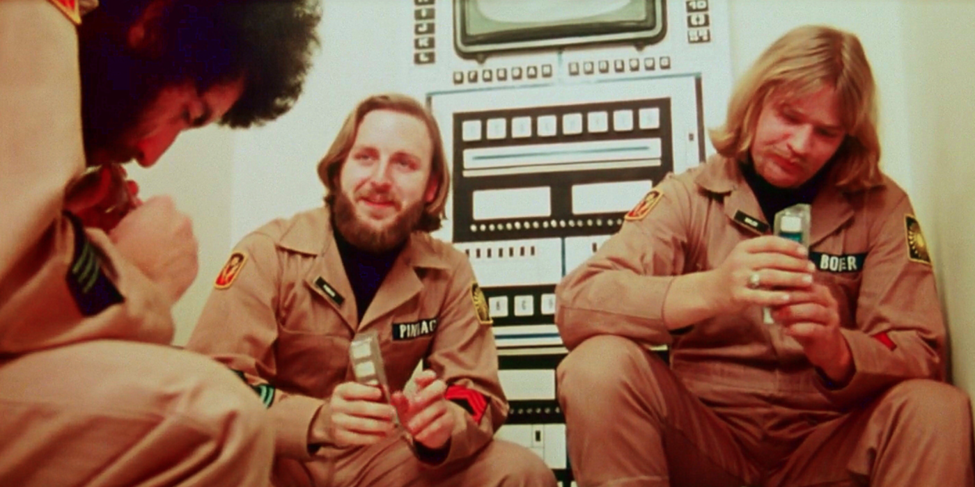 The astronauts in Dark Star sit together 