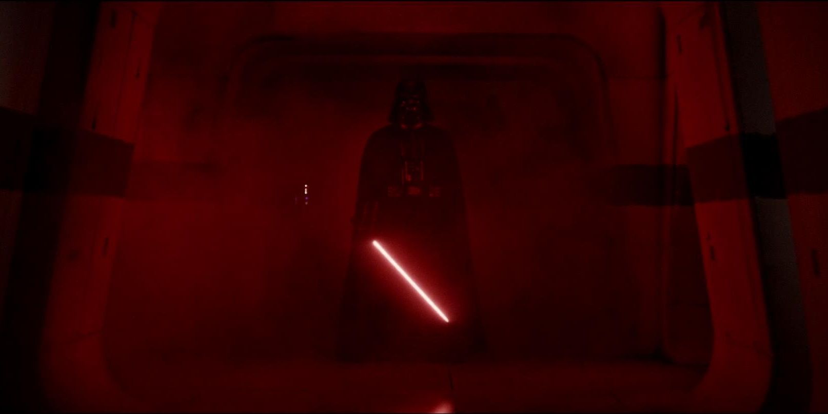 A hallway glows red from Darth Vader’s lightsaber in Rogue One