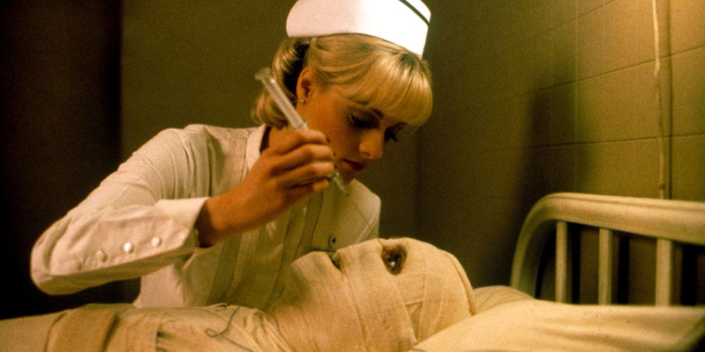 A nurse over a fully bandaged patient in Dead and Buried