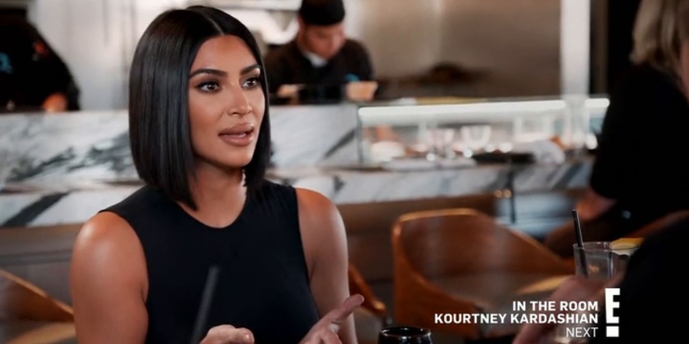 Kim talking to someone off camera at dinner on KUWTK