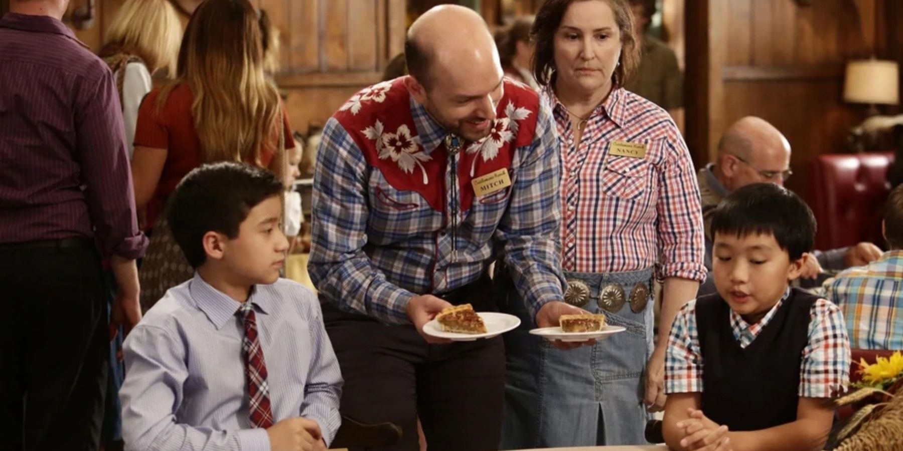The kids from the Huang family on Fresh Off The Boat sitting at a table at Cattleman's Ranch, being served pie.