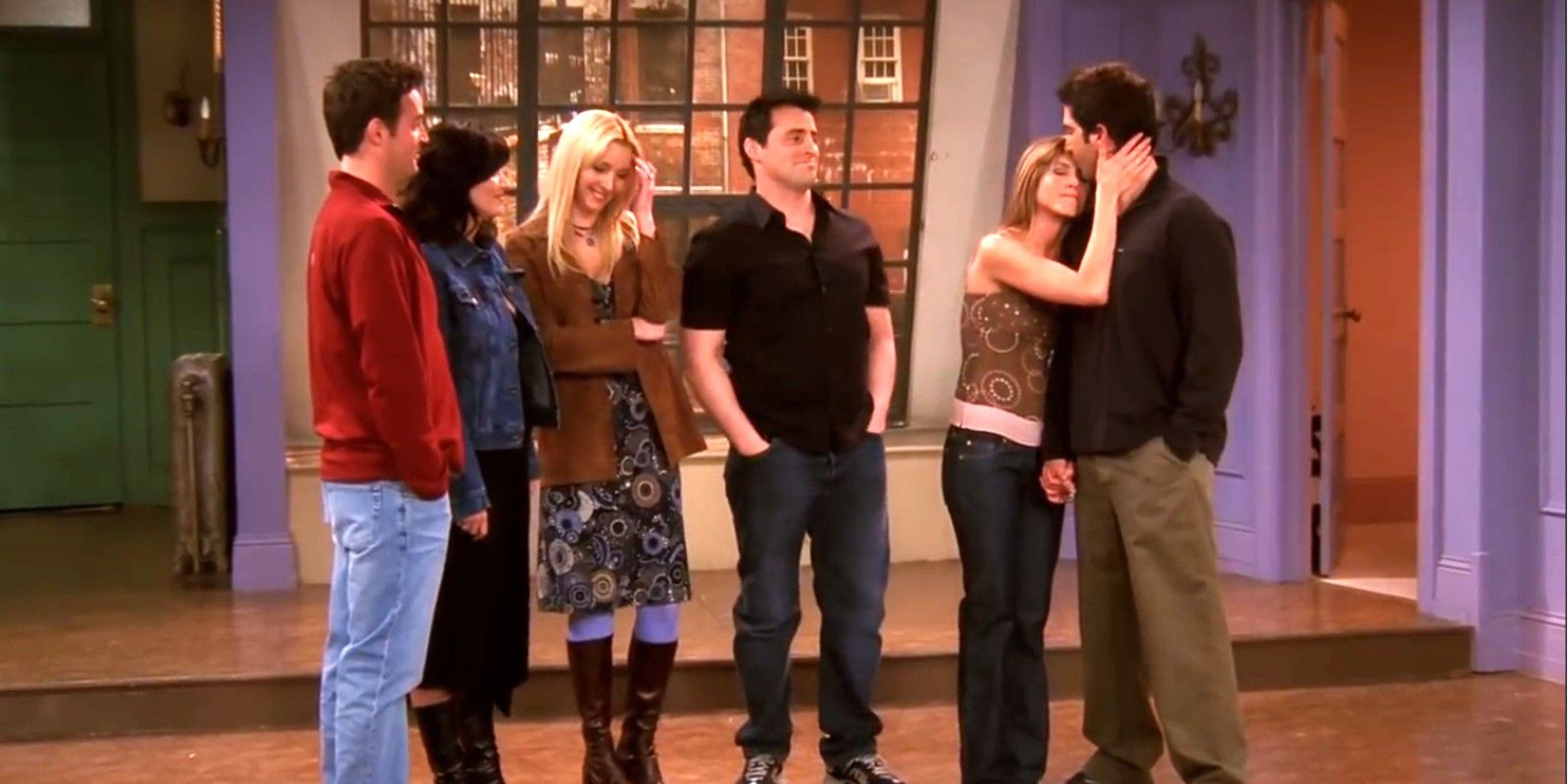 The cast of Friends standing in Rachel and Monica's apartment in the finale