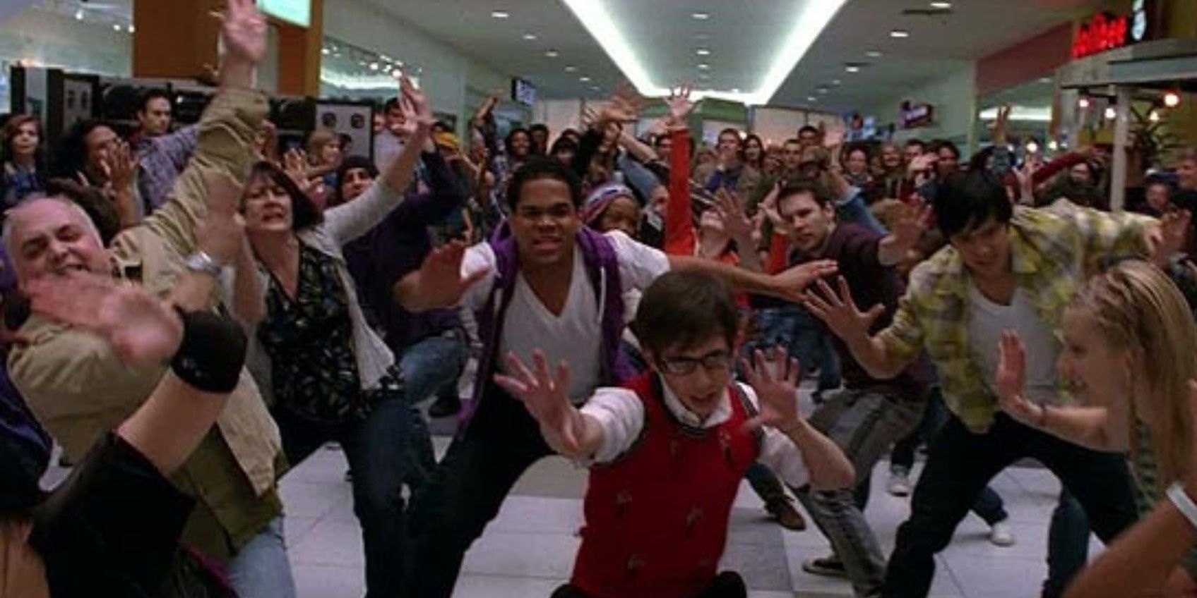 Artie leads a large crowd in a dance number in Glee