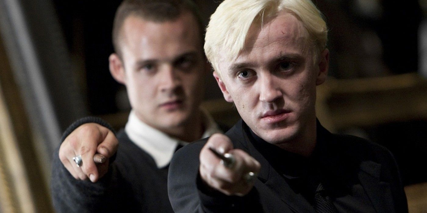 Goyle and Draco pointing their wands in the same direction in Harry Potter
