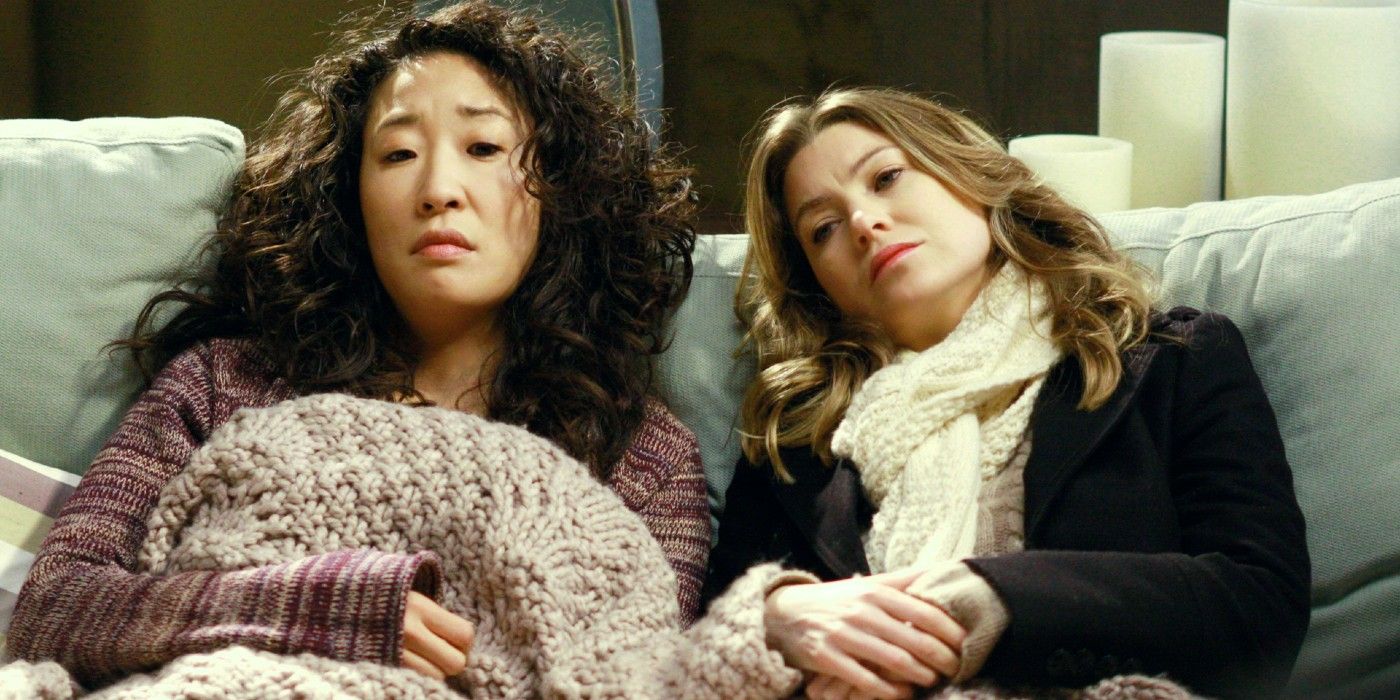 Cristina and Meredith lying on a couch on Grey's Anatomy
