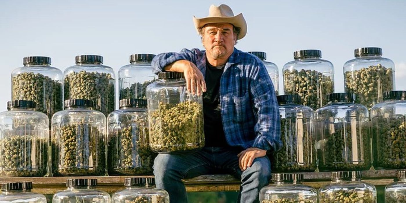 Jim Belushi posing with jars of legally-grown cannabis from is farm in Growing Belushi