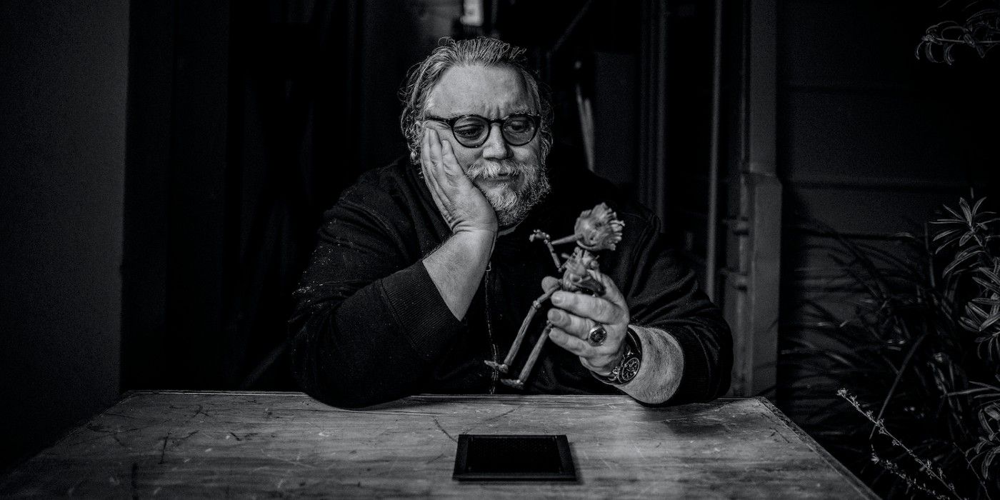 Guillermo del Toro with a Pinocchio figurine