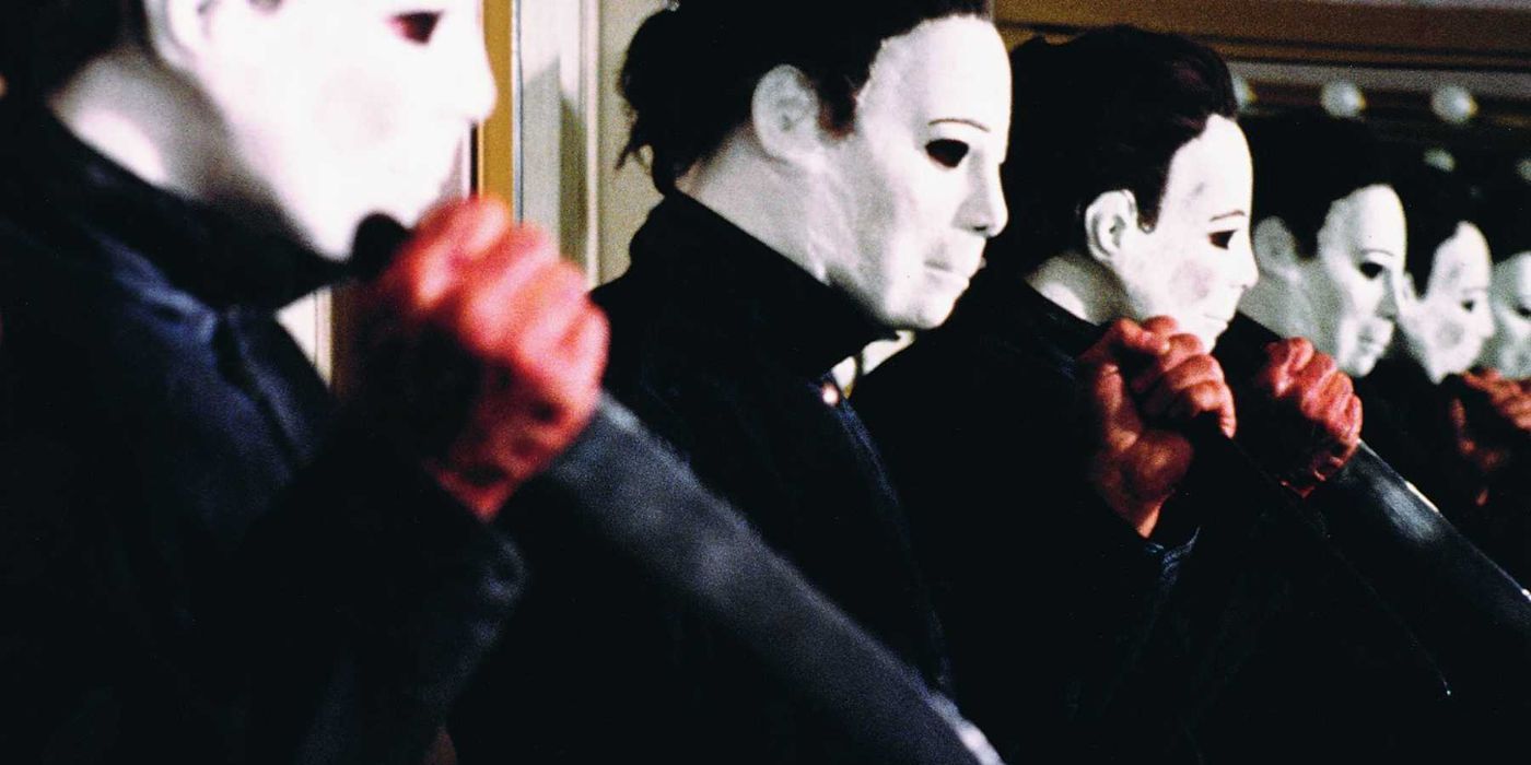 Halloween 4 Michael Myers holding a knife in front of a mirror.