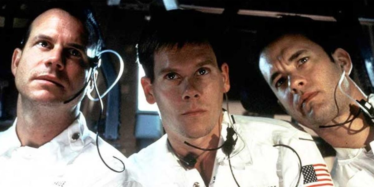 Bill Paxton, Kevin Bacon, and Tom Hanks watch a screen in Apollo 13