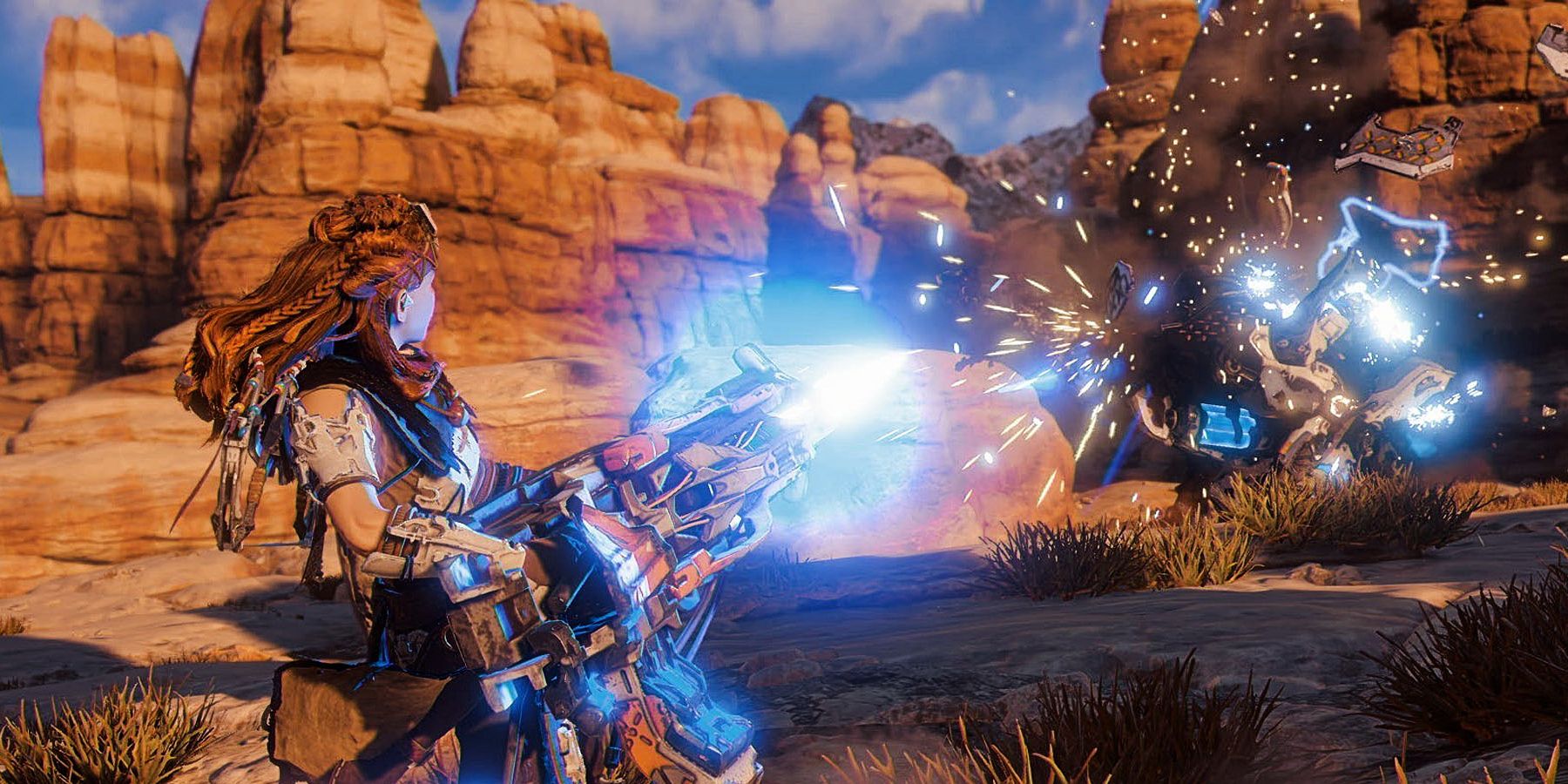 Aloy in Horizon Forbidden West battling an enemy while holding a large gun that shoots electric blasts