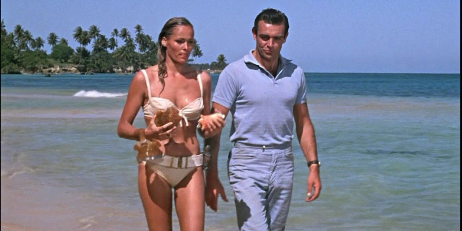 Bond talks to Honey Ryder on the beach in Dr No
