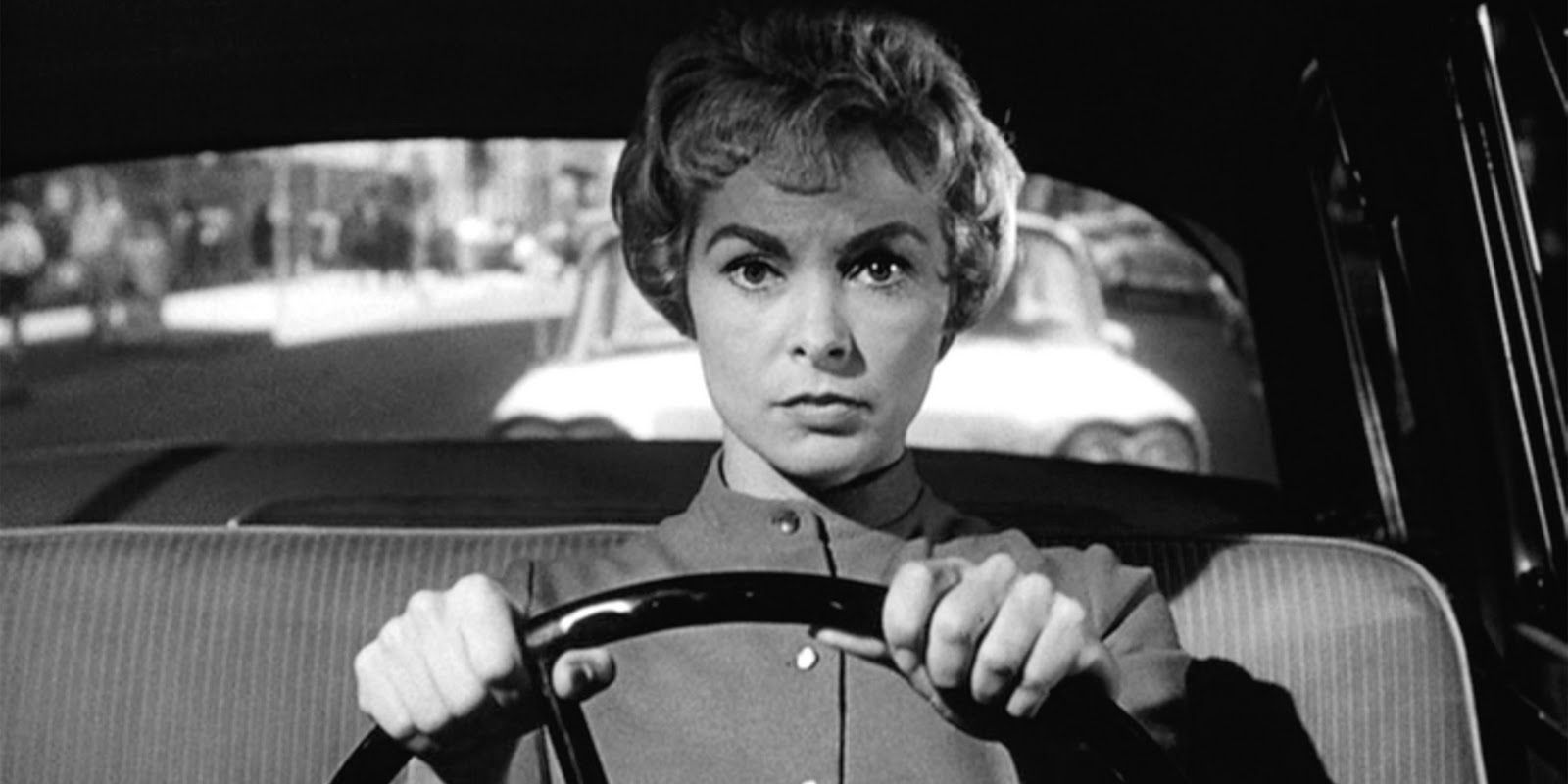 Janet Leigh driving a car in Psycho, looking determined.
