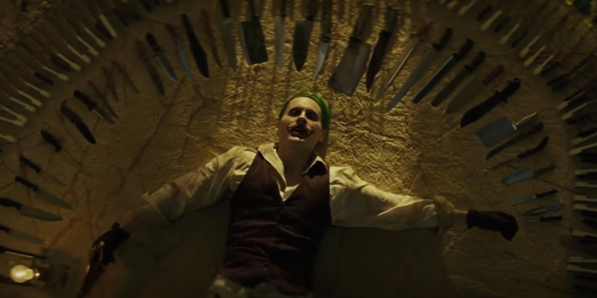 Jared Leto’s Joker lays surrounded by knives and weapons in Suicide Squad