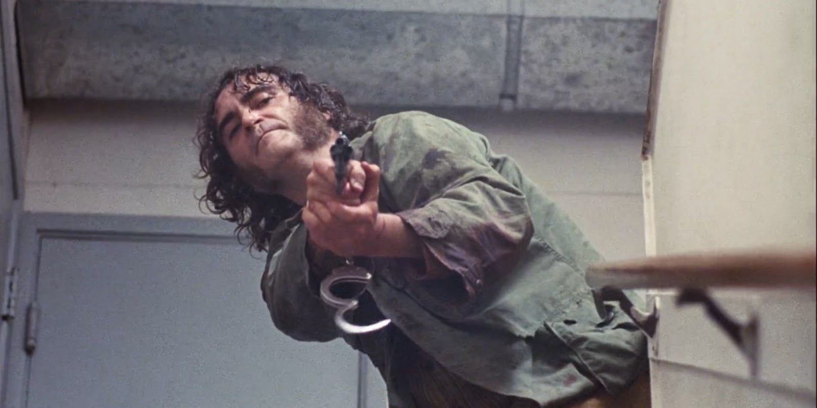 Joaquin Phoenix holding a gun in Inherent Vice